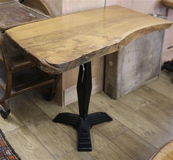 An oak top rustic table with a cast iron base W.99cm